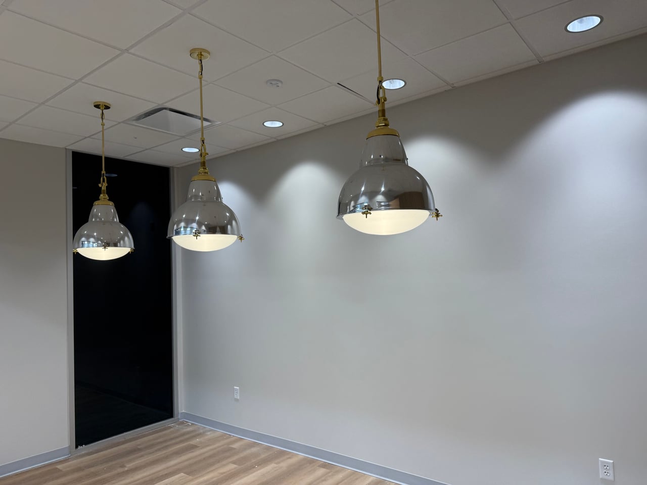 Three metal pendant lights and recessed ceiling lighting in Highland Lumber’s new offices in Fullerton