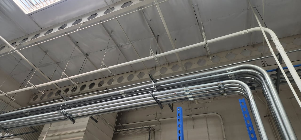 Overhead electrical conduit runs for the robotic paint booth project at Marvin Engineering Group