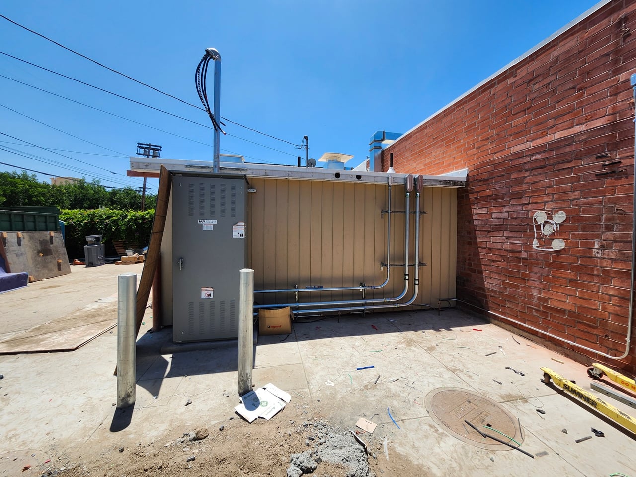 Freestanding electrical distribution board and exterior conduit at Mensano in Los Angeles