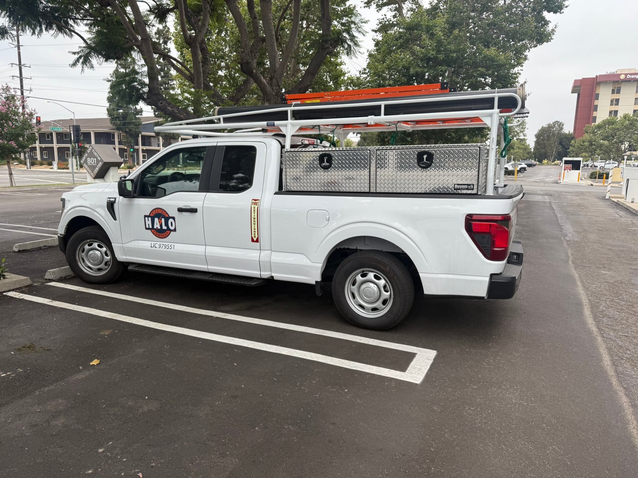 Halo Electric work truck with company branding, toolboxes and a ladder rack