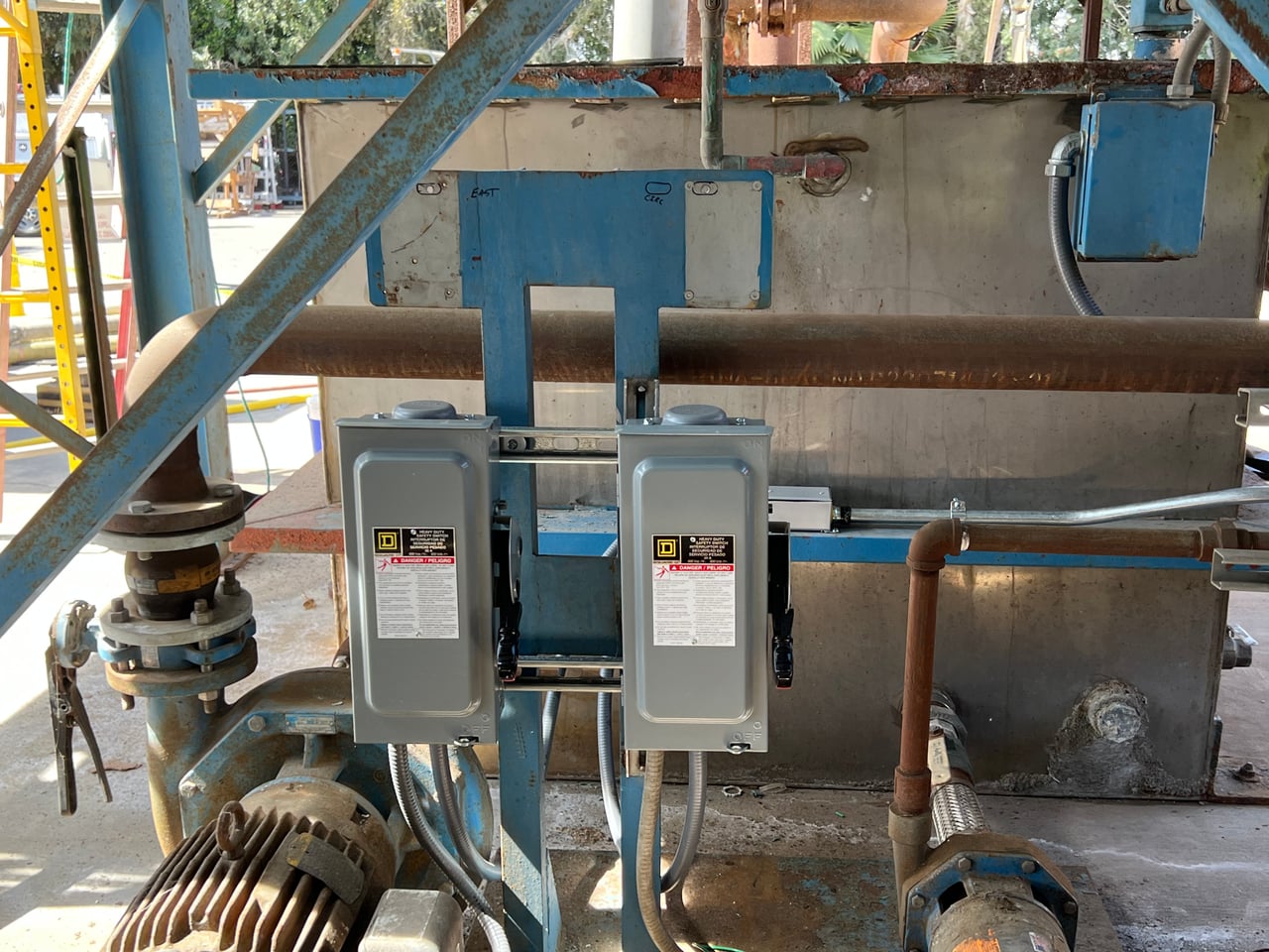 Electrical disconnect switches and conduit installed beside Trulite cooling tower equipment